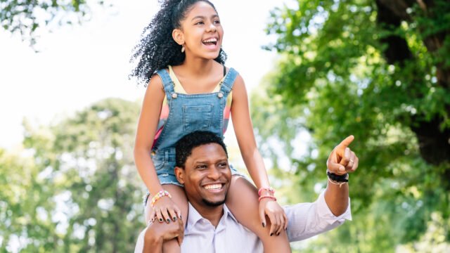 Father and daughter having fun together outdoors.